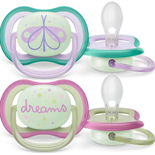 Load image into Gallery viewer, Two Philips Avent ultra air pacifiers for 0-6M babies, one with a butterfly design and the other with a 'dreams' text, both in green and purple colors with glow-in-the-dark buttons.