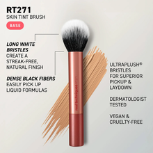 Load image into Gallery viewer, Promotional graphic for the Real Techniques RT271 Skin Tint Brush featuring a rose gold brush over a beige foundation swatch. Text highlights long white bristles for a streak-free finish, dense black fibers for liquid formulas, UltraPlush® bristles, dermatologist tested, vegan and cruelty-free.