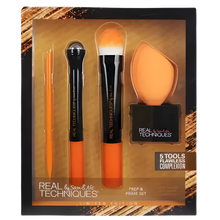 Load image into Gallery viewer, Set of makeup brushes and a sponge in packaging with 'Real Techniques' branding.