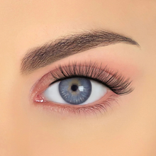 Load image into Gallery viewer, Closeup of AMY ultra curly natural false eyelashes on blue eye