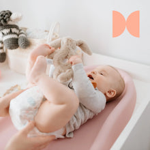 Load image into Gallery viewer, A baby lying on a changing mat, emphasizing the need for the Angelcare system's hygienic odor control.