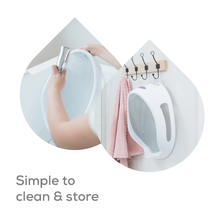 Load image into Gallery viewer, Angelcare Soft Touch Baby Bath Support being rinsed clean and stored by hanging
