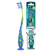 Load image into Gallery viewer, Aquafresh Big Teeth children's toothbrush for ages 6 to 8 years, featuring a blue and green handle with a suction foot, shown next to its teal retail packaging highlighting soft bristles and a gum-friendly flex zone.