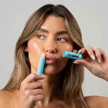 Load image into Gallery viewer,  Light-skinned model applying Dr.PAWPAW Coconut Lip Balm Stick on lips