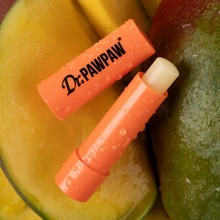 Load image into Gallery viewer, Close-up of Dr.PAWPAW Mango Lip Balm Stick open with tropical water droplets