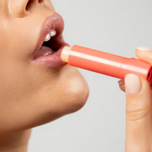 Load image into Gallery viewer, Woman applying Dr.PAWPAW Watermelon Lip Balm Stick to lips.