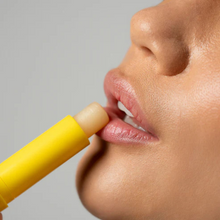 Load image into Gallery viewer, Close-up of model applying Dr.PAWPAW balm stick to lips