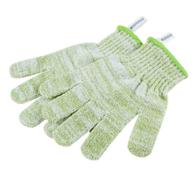 Load image into Gallery viewer, Overhead view of textured green EcoTools Bath and Shower Gloves stacked on a black background.