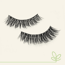 Load image into Gallery viewer, Flat lay of Eyecha Sunset vegan lashes with soft curl and wispy volume on off-white background