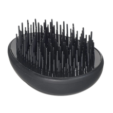 Load image into Gallery viewer, Isolated top-down view of the Kent Pebble Detangling Brush in solid black, highlighting its sleek, ergonomic, and compact pebble shape.
