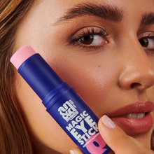 Load image into Gallery viewer, A close-up of a woman's face as she applies the Magic Eye Stick balm under her eye for a hydrated, radiant look.