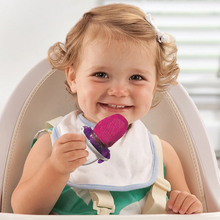 Load image into Gallery viewer, Baby holding and using the Munchkin Fresh Feeder Plus in pink with mesh pouch, suitable for fresh fruits and vegetables from 6 months.