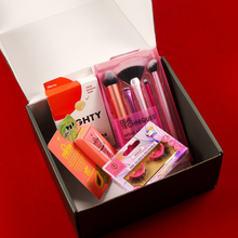 Load image into Gallery viewer, An open black subscription box packed with beauty essentials, including a pink Real Techniques makeup brush set, Mighty Patch acne treatment, and Violet reusable eyelashes.