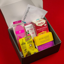 Load image into Gallery viewer, An open Botika subscription box showcasing contents like a Neostrata sheet mask, Yogi Tea, Real Techniques sponges, EcoTools BioBlender, and Dr. Pawpaw lip duo kit.