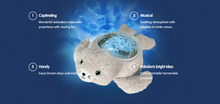 Load image into Gallery viewer, Pabobo Seal Aqua Dream Projector features: Animated underwater projections with moving fish, soothing lullabies and white noises, automatic shut-off timer, and a washable plush body with a removable electronic module.
