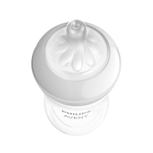 Load image into Gallery viewer, A high-angle, close-up shot of a Philips Avent Natural baby bottle nipple and white screw ring against a solid black background.