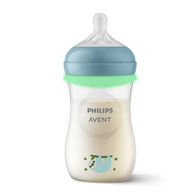 Load image into Gallery viewer, A Philips Avent Natural baby bottle filled with milk, featuring a blue cap, a green screw ring, and a cute illustration of a blue sloth hanging from a branch with green stars.