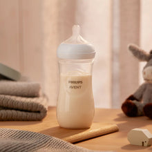 Load image into Gallery viewer, Philips Avent Natural Response Baby Bottle 330ml displayed in a nursery setting