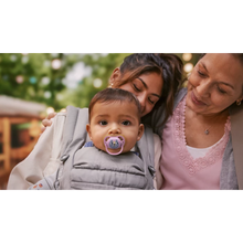 Load image into Gallery viewer, An infant in a grey baby carrier using a pink tiger-themed Philips Avent Ultra Air soother (SCF087/13) while being held by adults outdoors.