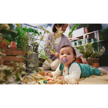 Load image into Gallery viewer, An infant crawling in an indoor garden while using a lavender purple Philips Avent Ultra Soft soother (SCF091/43).