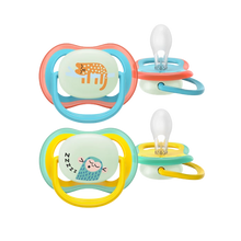 Load image into Gallery viewer, A 2-pack of Philips Avent Ultra Air Nighttime soothers (SCF376/32) for 18m+ featuring glow-in-the-dark tiger and monkey designs with extra-firm teats.