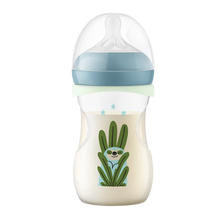 Load image into Gallery viewer, A Philips Avent baby bottle on a black background, featuring a blue cap, a light green glow-ring, and a cute illustration of a sloth peeking out from behind large green leaves.