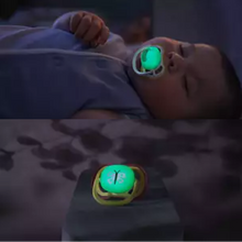 Load image into Gallery viewer, A split-screen showing a sleeping baby using a glowing Philips Avent Ultra Air Nighttime soother and a close-up of the soother's glow-in-the-dark button.