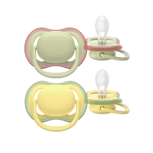 Load image into Gallery viewer, A 2-pack of Philips Avent Ultra Air soothers for 18m+ toddlers in neutral green and yellow, featuring extra-large airholes to keep sensitive skin dry.