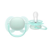 Load image into Gallery viewer, A close-up of a mint green Philips Avent Ultra Soft soother for infants 0–6 months, featuring a flexible shield for sensitive skin and a clear silicone nipple.