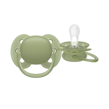 Load image into Gallery viewer, A close-up of a sage green Philips Avent Ultra Soft soother for toddlers 18 months and older, featuring a flexible shield for sensitive skin and a clear silicone nipple.