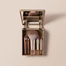 Load image into Gallery viewer, Open mirrored compact case holding five mini makeup brushes from the Real Techniques On-The-Glow Mini Brush Set on a neutral beige background.