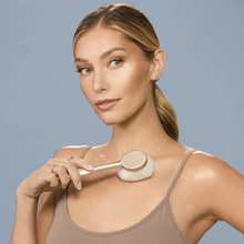 Load image into Gallery viewer, Woman applying bronzer to collarbone using Real Techniques glow brush.