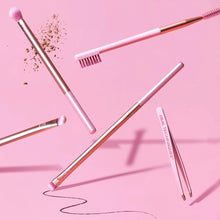 Load image into Gallery viewer, Real Techniques Naturally Beautiful Eye Set tools shown in a creative lifestyle shot, featuring pink and rose gold vegan makeup brushes for natural eye and brow looks.