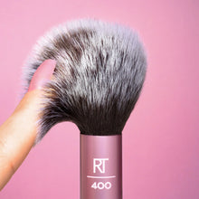 Load image into Gallery viewer, Detail shot of the soft, two-tone synthetic bristles of the Real Techniques RT 400 Brush, highlighting the quality and plushness of the brush head for makeup application.