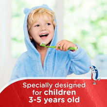 Load image into Gallery viewer, A happy young boy in a blue hooded robe brushing his teeth with an Aquafresh toothbrush specially designed for children 3-5 years old.