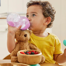 Load image into Gallery viewer, A toddler in a yellow shirt drinking from a purple weighted straw trainer cup, seated at a table with a bowl of fresh berries and a plush teddy bear nearby.