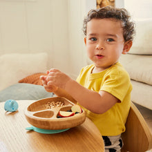 Load image into Gallery viewer, Toddler enjoying a meal with Munchkin Bambou™ divided plate, featuring non-toxic bamboo and a non-slip suction base.