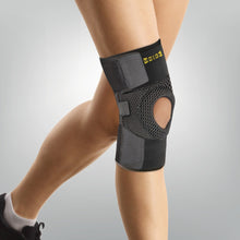Load image into Gallery viewer, Uriel Knee Support - One Size featuring a breathable mesh wrap and open-patella design for adjustable compression and kneecap stability.