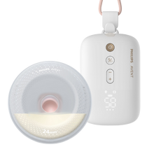 Load image into Gallery viewer, Mother using Philips Avent wearable breast pump hands-free while seated, holding control unit.