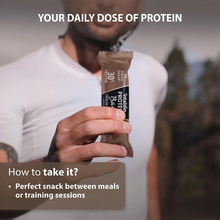 Load image into Gallery viewer, A man in athletic wear holding a Vitaldin chocolate protein bar outdoors, with text describing it as a perfect snack for between meals or training sessions.