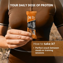 Load image into Gallery viewer, A person holding a Vitaldin Salted Caramel Protein Wafer, labeled as a perfect snack for between meals or training sessions.