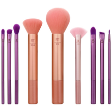 Load image into Gallery viewer, A collection of nine makeup brushes with pink and purple bristles, displayed with the brand 'Real Techniques' visible on the handles.

