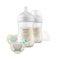 Two Philips Avent bottles with natural response teats and color頂line design, accompanied by two soothers. The bottles are filled with a liquid, possibly milk, and the soothers are in a color that matches the bottles.