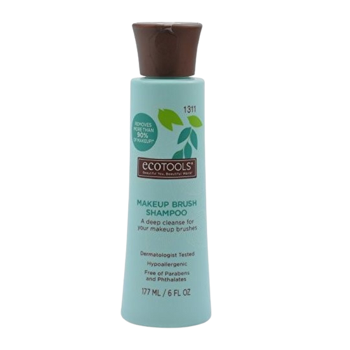 A bottle of ECO TOOLS MAKE UP BRUSH CLEANSING SHAMPOO with a green label and a capacity of 1311 ml.