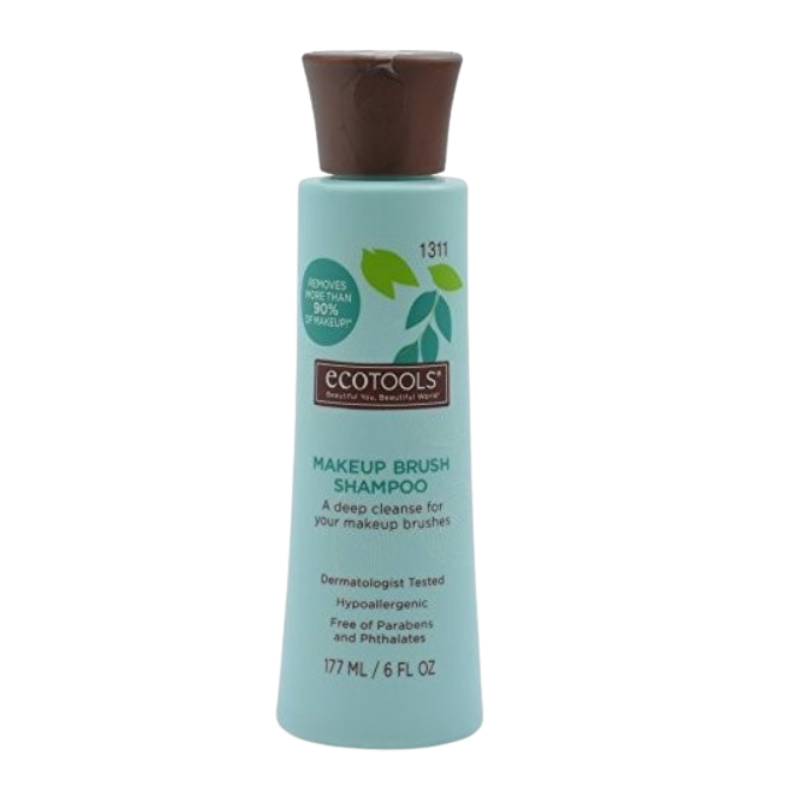 A bottle of ECO TOOLS MAKE UP BRUSH CLEANSING SHAMPOO with a green label and a capacity of 1311 ml.
