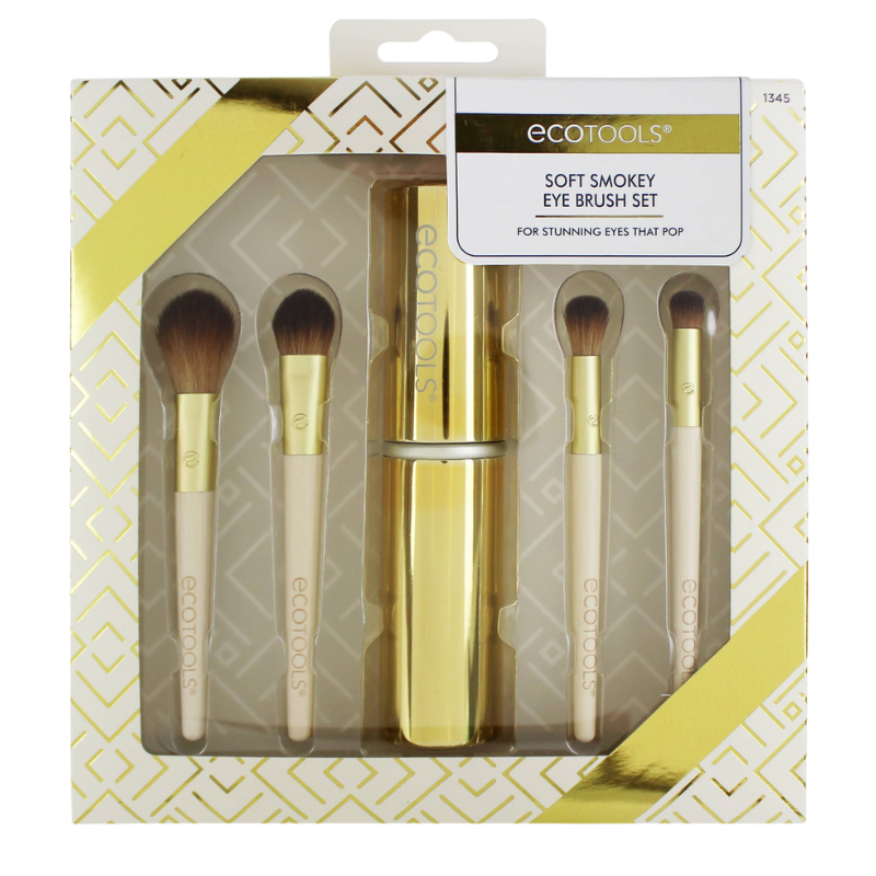 A set of ECO TOOLS soft smokey eye brushes with beige handles and gold ferrules, presented in a packaging with a geometric pattern.