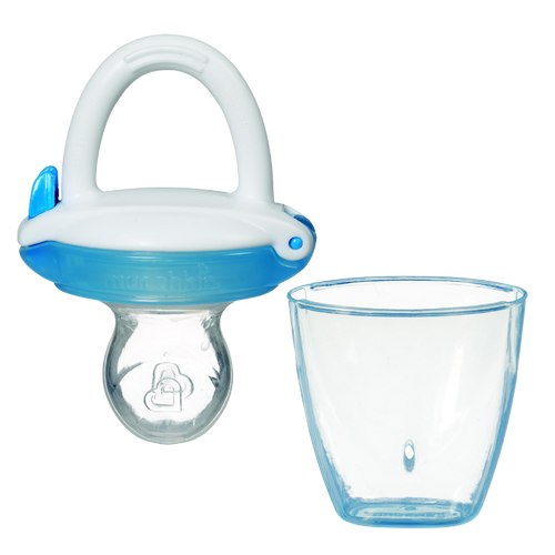 A Munchkin baby food feeder in blue colour with a small hole at the bottom and an attached pouch, alongside an empty clear container.