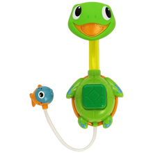 Load image into Gallery viewer, A colourful Munchkin Turtle Shower toy with a green base and a yellow neck, with suction cups on the bottom and a small blue fish-like figure attached to it.
