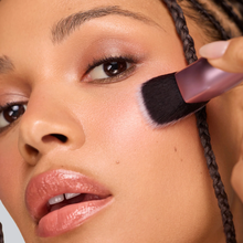 Load image into Gallery viewer, Person applying makeup using the Real Techniques Cheek Hugging Contour Brush.
