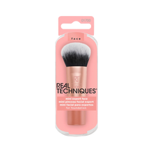 Load image into Gallery viewer, Front packaging of the Real Techniques Mini Expert Face Brush for foundation, featuring a compact rose gold brush with dense black-and-white bristles in pink packaging.
